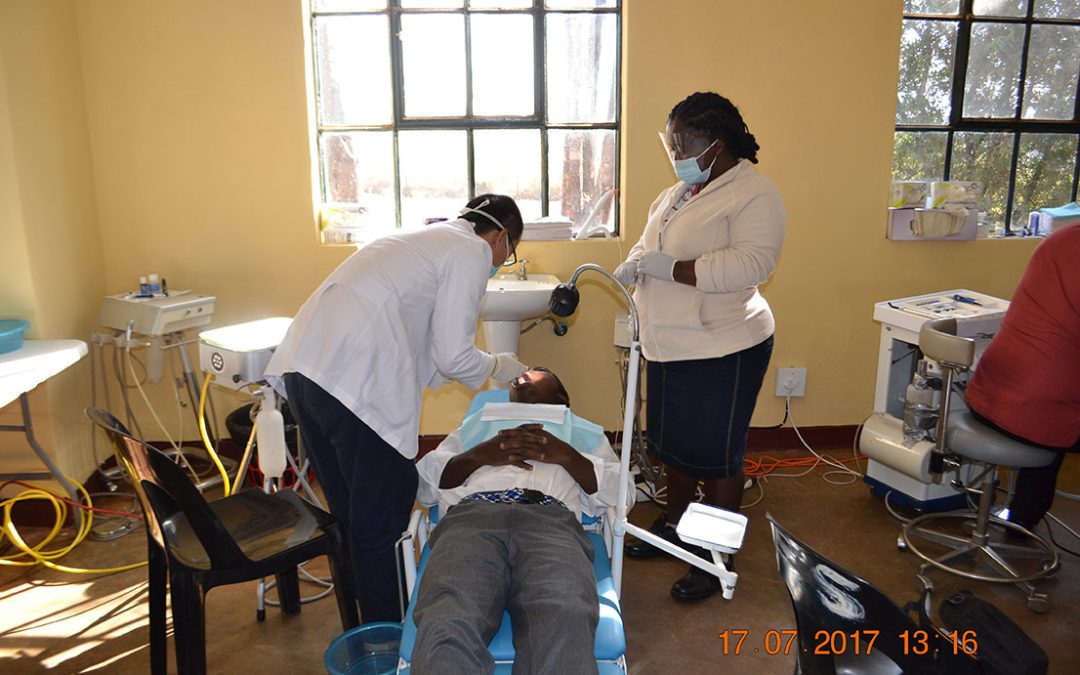 Dental team at work — tooth extraction